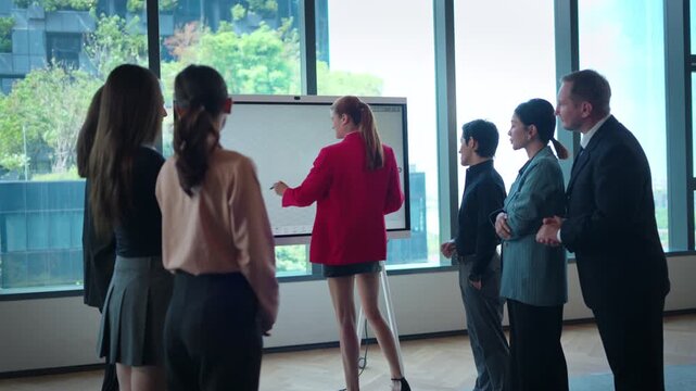 A group of business professionals are discussing strategies and ideas on a modern task board to reach a conclusion for a new project