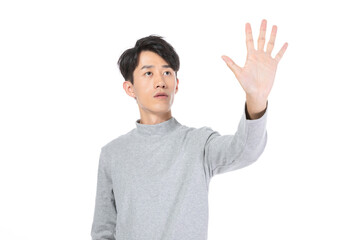 Fototapeta premium Young man reaching out to touch an invisible interface