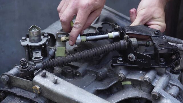 old gear shift box from a front-wheel drive car installing cables and shifting gears disassembly for repair