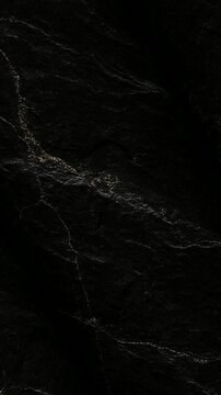 Macro view of rotating Sub Bituminous Coal surface displaying unique dull black geological formations and embedded crystal minerals for energy resource