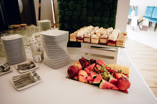 Catering buffet with fresh fruits and appetizers in modern office conference room. Corporate catering, business lunch, office party, event food service, healthy snacks, conference coffee break