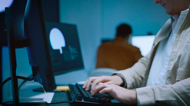 Close up of young male IT specialist hand typing on keyboard working on computer software programming code and artificial intelligence data analysis in office