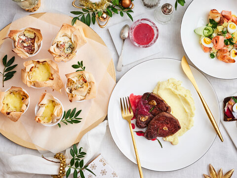 Festive holiday dinner with creamy mashed potatoes, tender beef, and savory quiches, perfect for family gatherings and celebrations