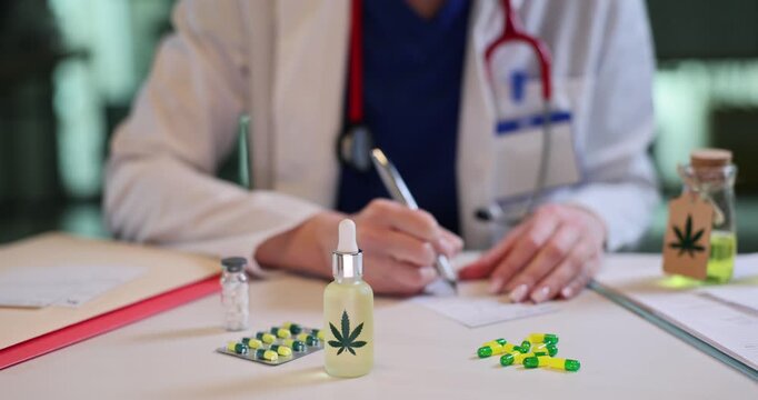 Female doctor prescribes medications with cannabis as sits at desk. Woman physician writes RX for drugs with marijuana ingredients in hospital