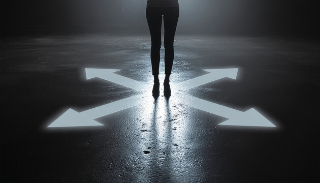 Silhouette of Person at Crossroads with Glowing Arrows for Direction Choice