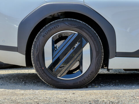 June 3, 2026, Gangneung, South Korea - Close-up of a white Kia car's front wheel with Kumho Solus tire on gravel