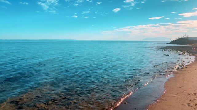 Peaceful cinematic view of a calm blue sea coastline and sandy beach on a sunny day in Edirne, Turkiye