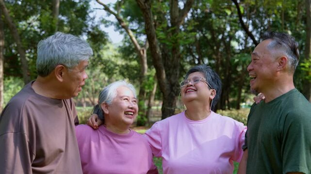 Joyful Senior Moment: A group of mature adults in relaxed sportwear share a moment of laughter in a park. their bond of friendship is evident through a scene of pure connection and tranquility.
