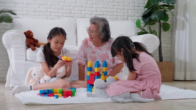 Family Building Blocks: Two young girls and their grandmother engage in a heartwarming afternoon of playful construction, crafting colorful towers and sharing moments of joy and connection.