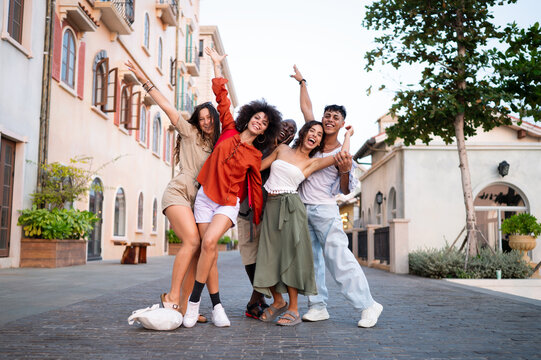 Multicultural group enjoys a carefree moment while traveling together, sharing laughter in the city