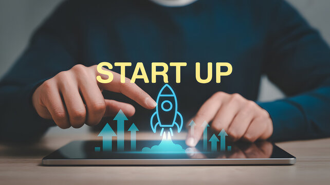 Person launching startup business on tablet with rocket icon