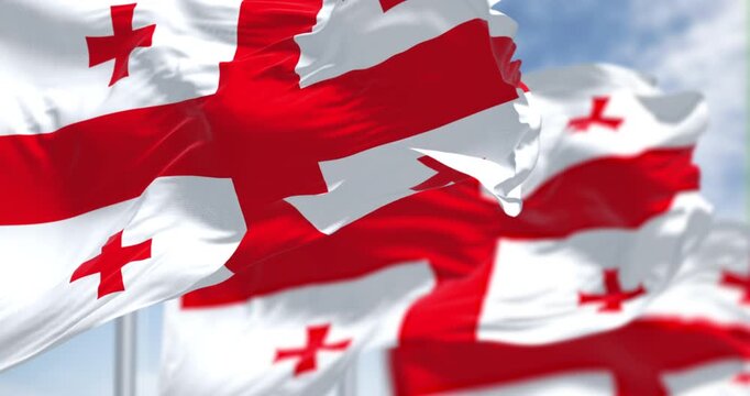 National flags of Georgia waving in the wind on a clear day