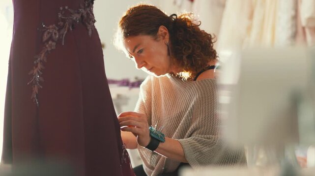 Fashion designer creates custom dress in studio during daytime work hours