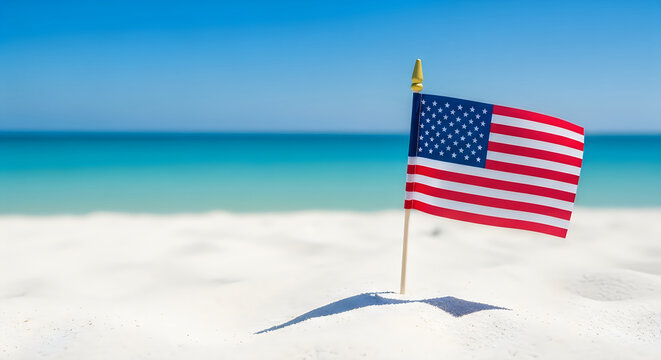 American flag waving on sandy beach with clear blue ocean and sky background