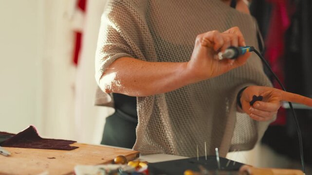 Creating unique designs in a fashion studio while working with fabrics and tools