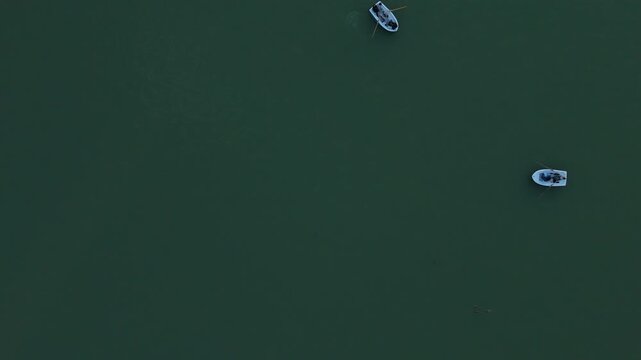 Top down drone shot of rowing boats on a lake