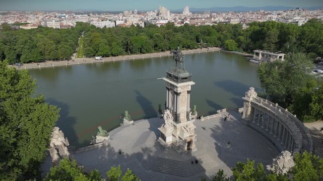 Drone shot panning around the monument of King Alfonso XII and the lake in El Retiro Park