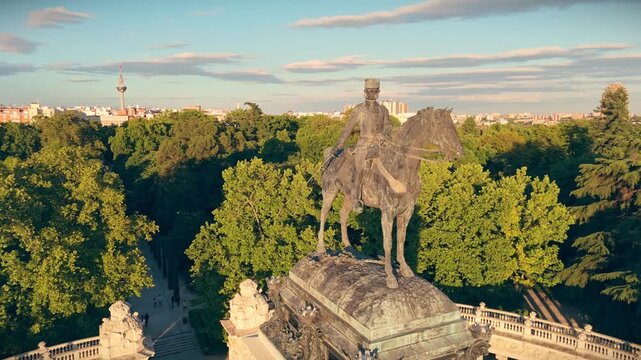Spectacular drone orbit shot around the bronze equestrian statue of King Alfonso XII monument in Retiro Park