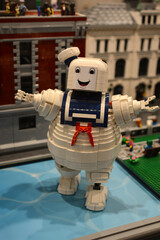 Naklejka premium A Lego sailor against the backdrop of colorful houses made from Lego bricks.