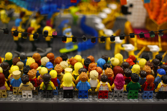 A group of plastic toy miniature figures of people standing together. Lego exhibition. Poland. Warsaw.