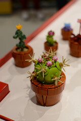 Naklejka premium A cactus made of Lego bricks on a table. Lego constructor