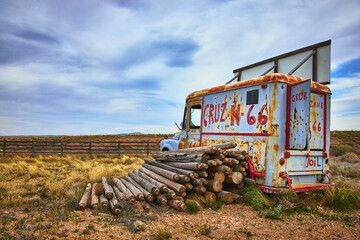 Fototapeta premium Rustic Vintage Truck and Logs on Route 66 in Arizona Countryside