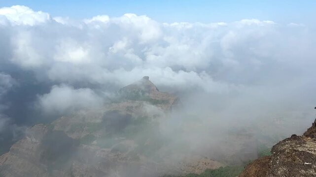Rohida peak seen in between the cloud movement during pre monsoon season in western ghats of India.