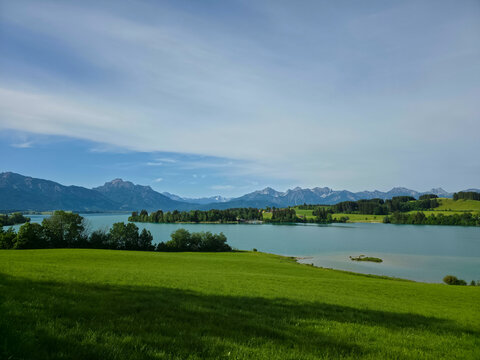 germany, magnificent mountain landscape overlooking illasbergsee framed by emerald meadow and peaceful forested waterfront