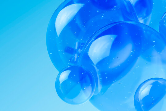 3D liquid blue spheres in transparent glass on minimal background