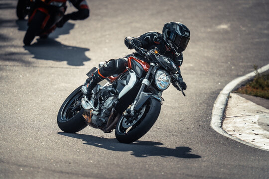Regular training in Riga, Latvia, Bikernieki on 12-05-2026  Motorcyclist leaning into curve on road