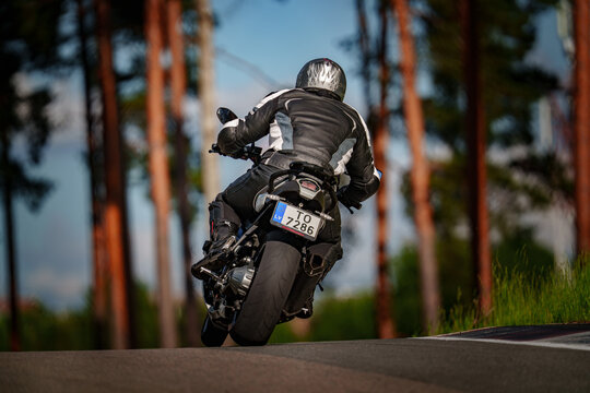 Regular training in Riga, Latvia, Bikernieki on 12-05-2026  Motorcyclist Riding on a Curved Road in a Forest