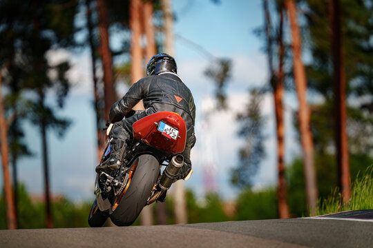 Regular training in Riga, Latvia, Bikernieki on 12-05-2026  Motorcyclist executing wheelie in forest during clear day
