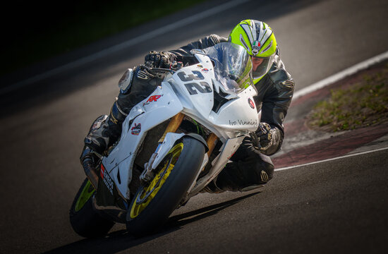 Regular training in Riga, Latvia, Bikernieki on 12-05-2026  Motorcycle Rider Navigating a Turn on Race Track