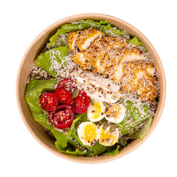 Fresh chicken salad with boiled egg tomatoes seeds and grated cheese served in takeaway bowl isolated