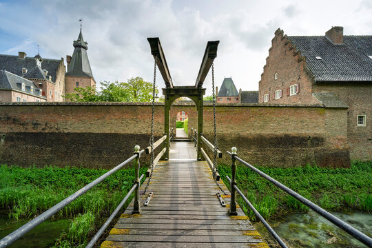 Damp wooden planks lead to a brooding, ancient castle.
