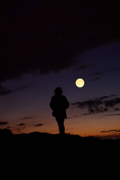 Woman observing stars, planets, Moon and other celestial objects.