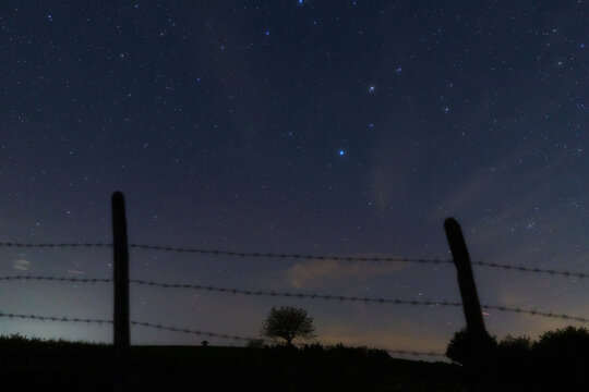 Constellations, landscape, Milky Way stars on a dark countryside skies.