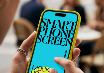 Hand Holding Smartphone Screen Mockup in Public Space