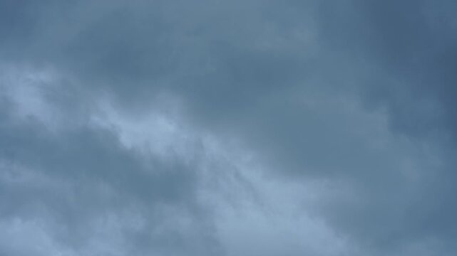 Timelapse Storm cloud sky dark weather rain dramatic gray overcast atmosphere with moody blue cloudscape texture across horizon natural outdoor climate background