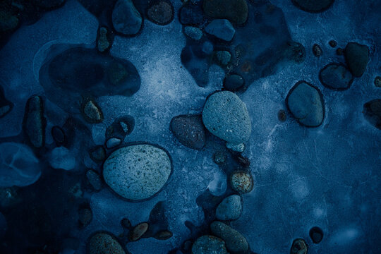 Water and stones at the lake surface in evening light