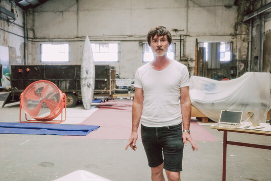 Barber Prepares for haircut in Industrial Space