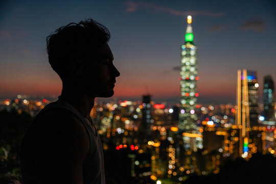 Man silhouette with Taipei 101 at dusk