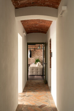 Corridor leading to living space with natural light