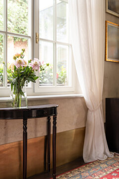Flowers by window with soft natural light
