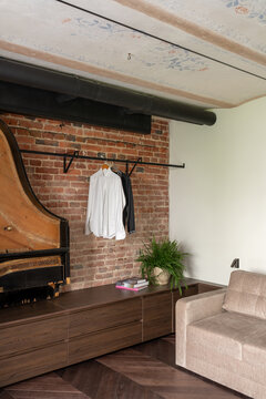 Interior detail with brick wall and wooden cabinet
