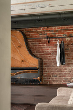 Living room detail with brick wall and piano element