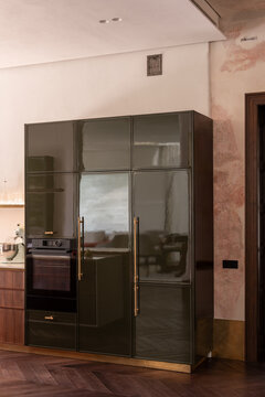 Dark cabinetry with integrated kitchen appliances