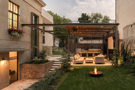 Backyard lounge with fire pit at dusk