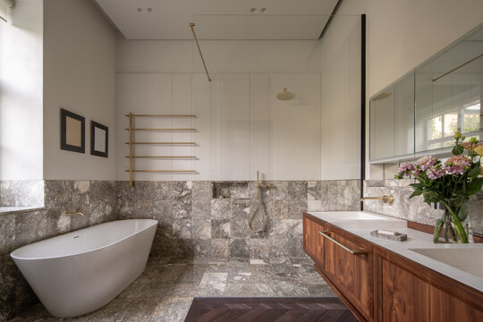Spacious bathroom with tub and wooden vanity