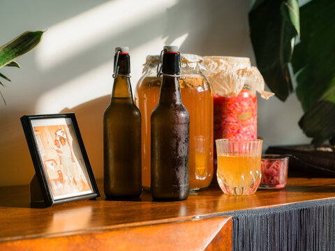 Bottles and Jars on a Wooden Table in Bright Sunlight
